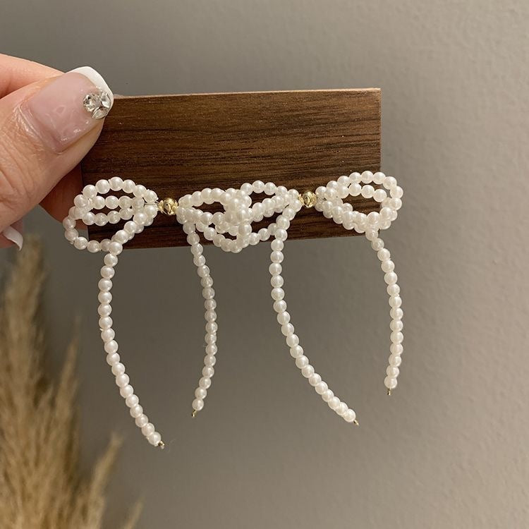 Women's pearl bow earrings